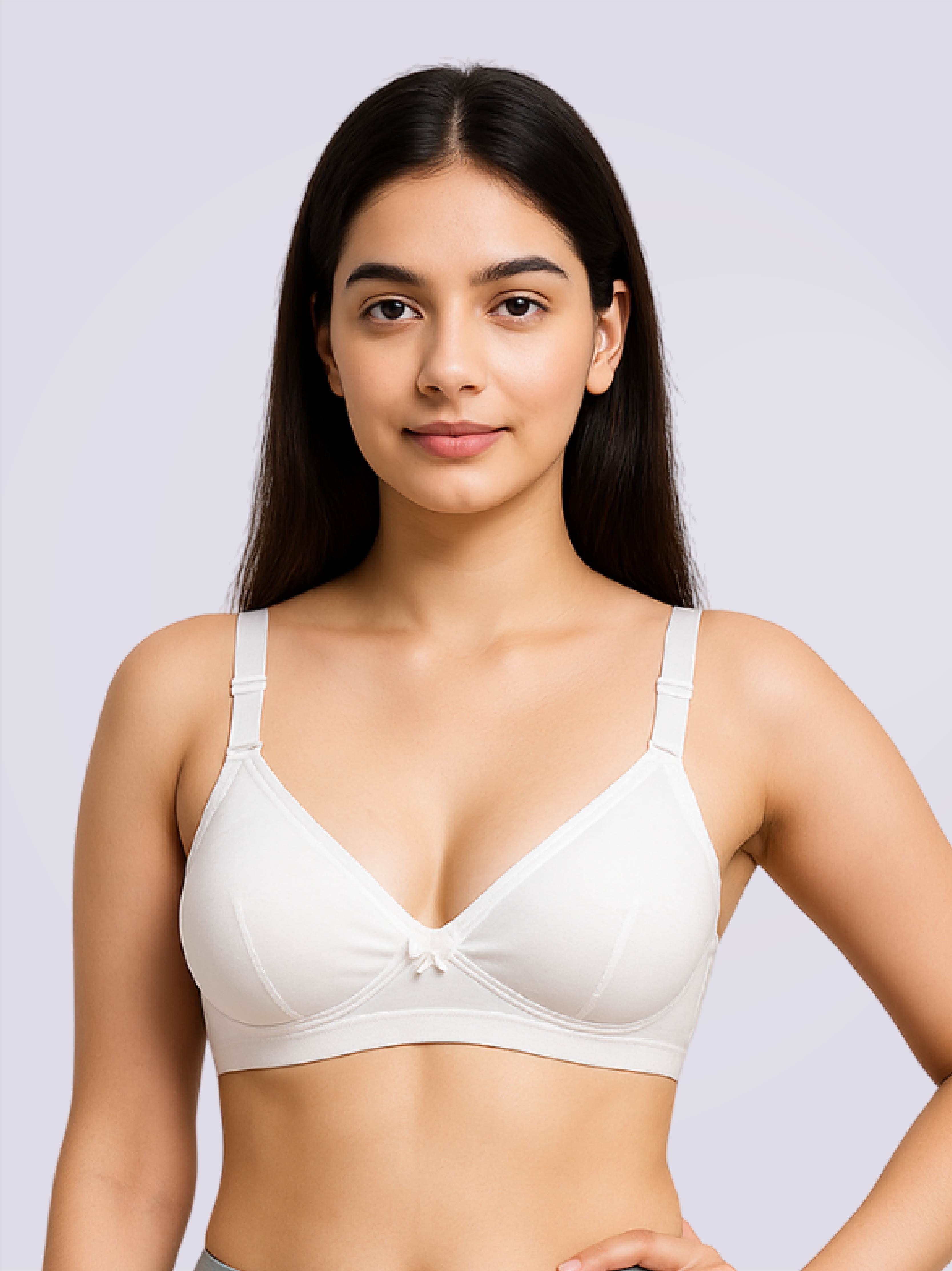 Woman wearing a white bra against a light gray background